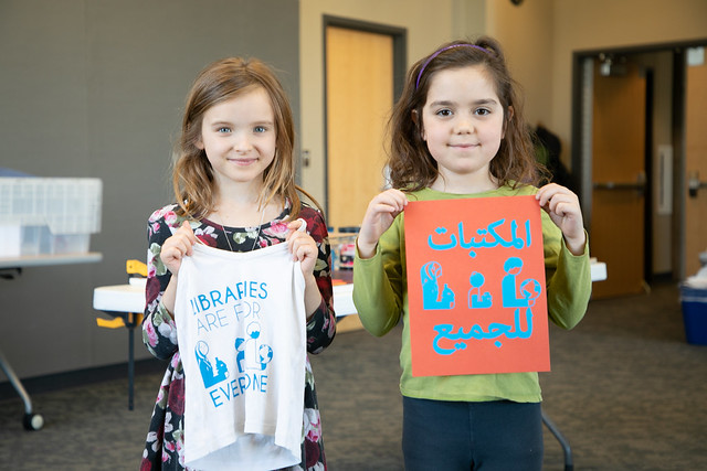 Two girls holding newly-printed 