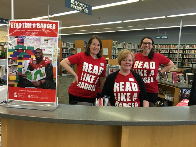 Pinney Librarians show off their summer reading spirit at the reference desk