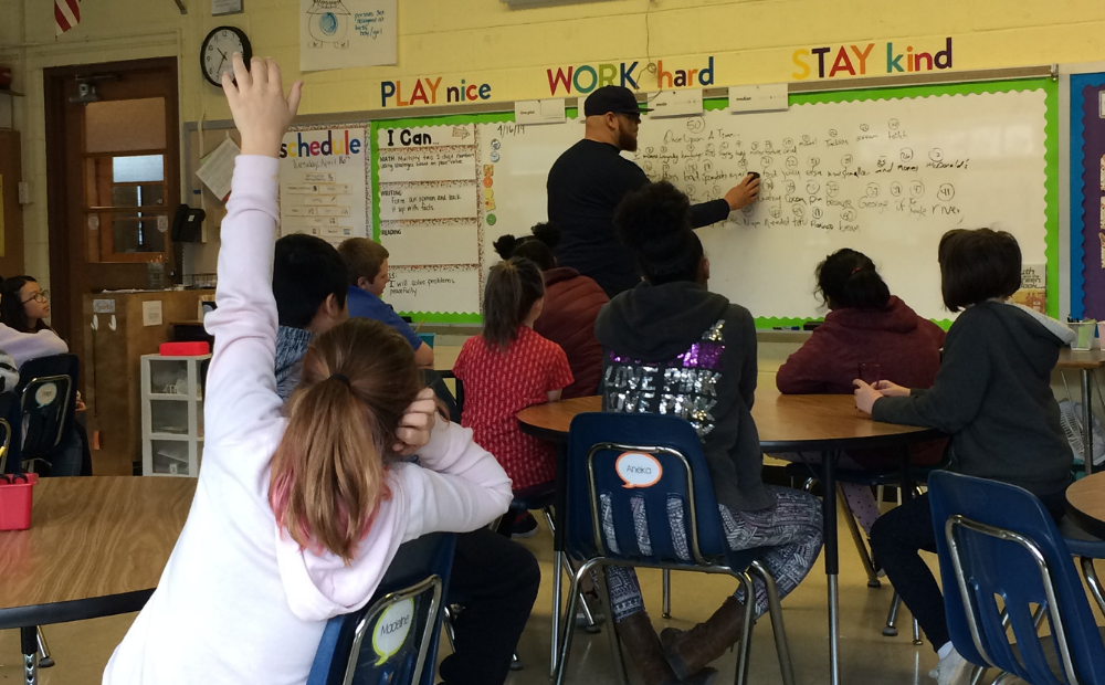 Library staff at whiteboard teaching class