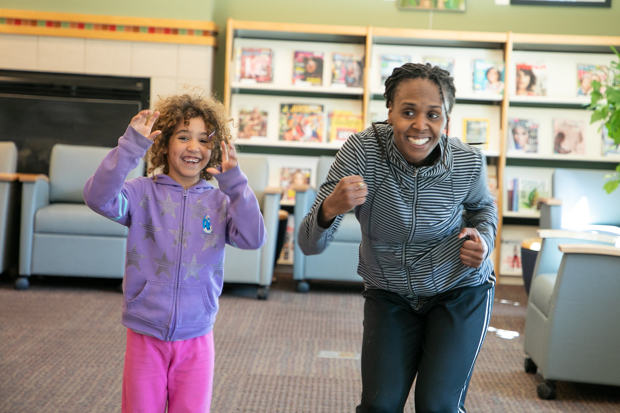 Mother and daughter dance in the library