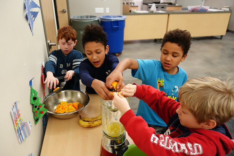 Chef Lily's students juice oranges for one of her recipes during cooking class