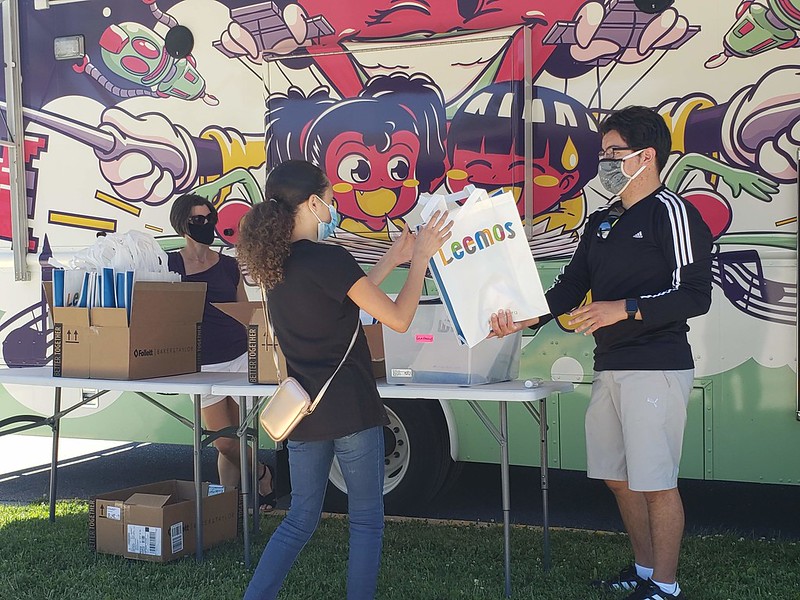 Madison Public Library's Dream Bus distributes bags of books to children