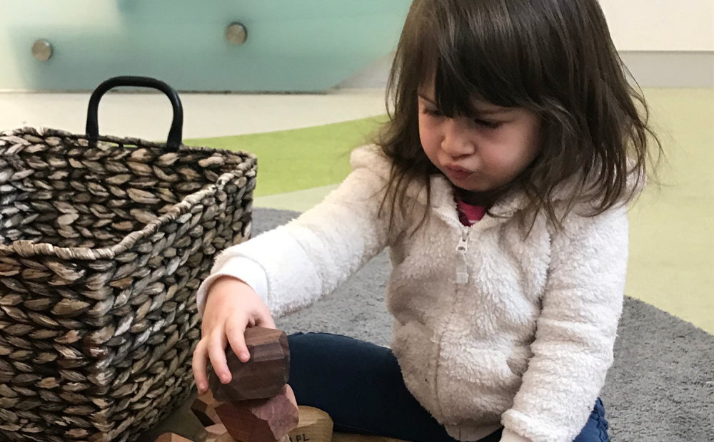 Child plays with wooden blocks