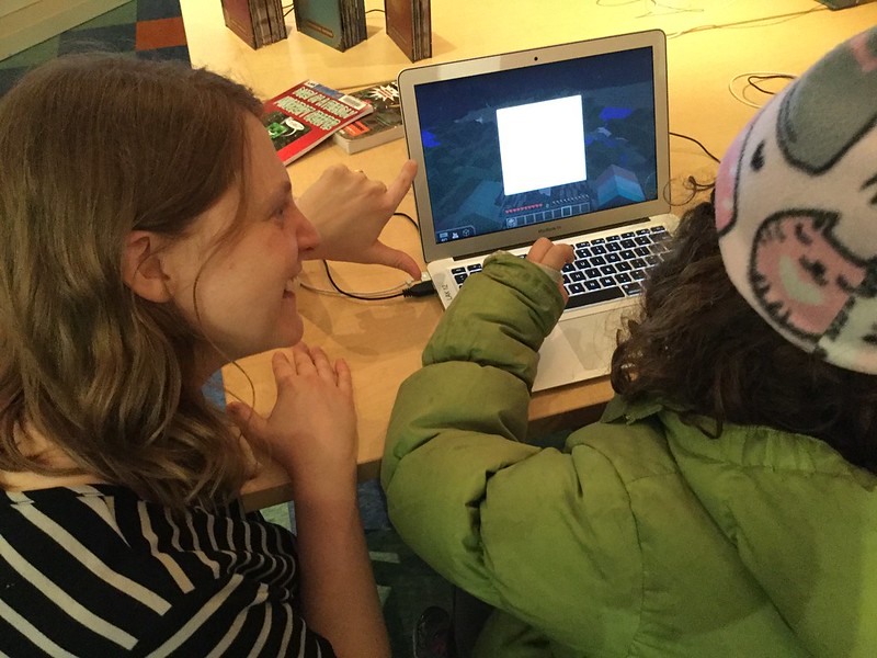 Adult and child working on a computer.