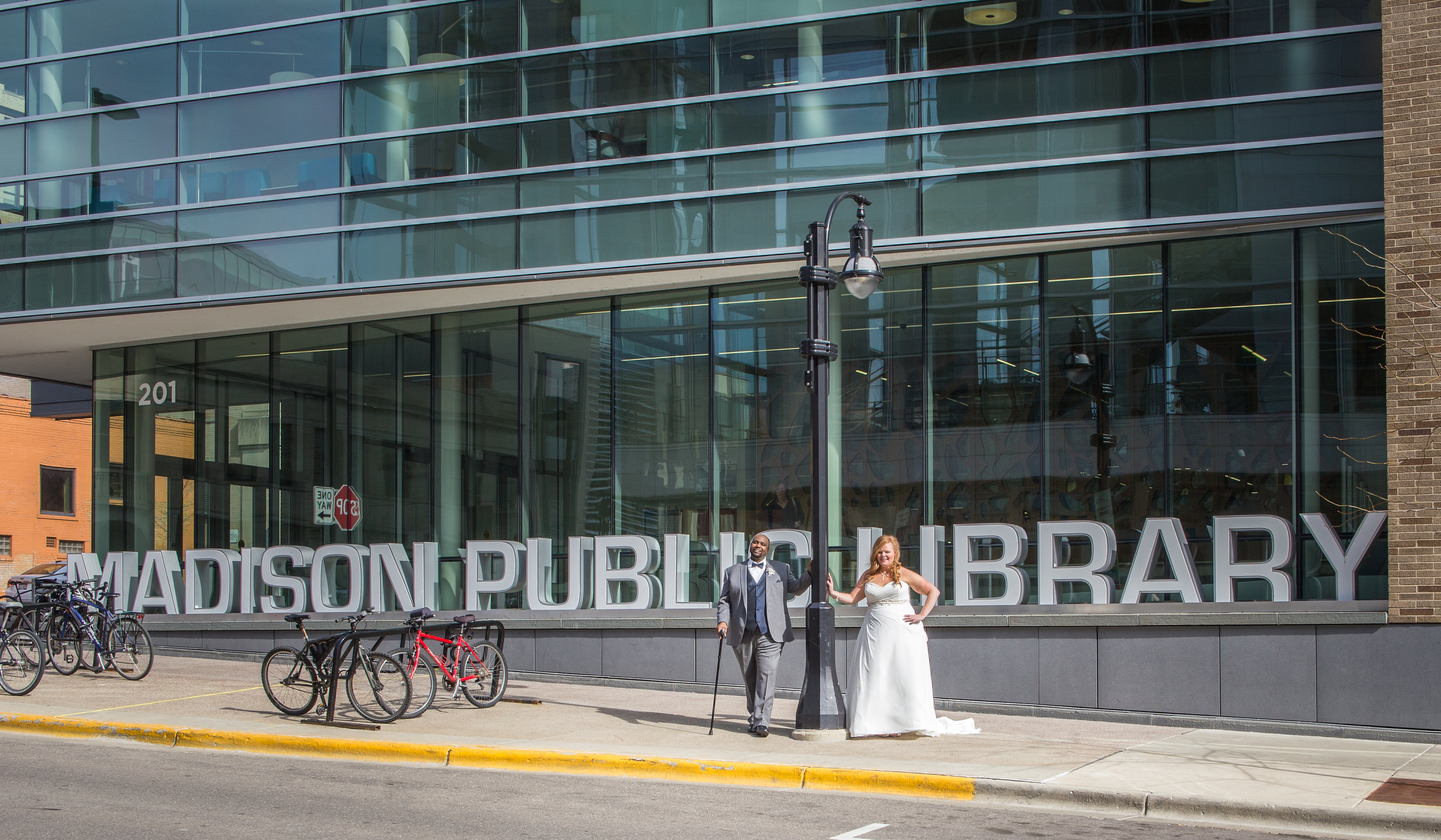 Bride & Groom posing in front of Madison Public Library Sign