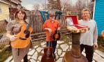 Three folk musicians pose together - their group name is Flying by the seat of our pants